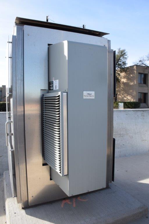 4-Types-Heat-Transfer-Mechanisms-Used-for-Cooling-Electrical-Enclosures Foto muestra un aire acondicionado montado en un tablero eléctrico.