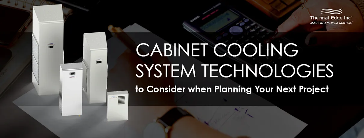 Multiple electrical enclosure cooling units in different sizes displayed on a work surface, representing cabinet cooling system technologies for industrial applications.